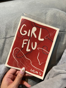 Photo of Girl Flu zine held in a hand.