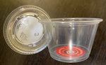 Load image into Gallery viewer, A plactic cup (4oz) with a red Changing The Flow sticker in the base. To the left is the lid. 

